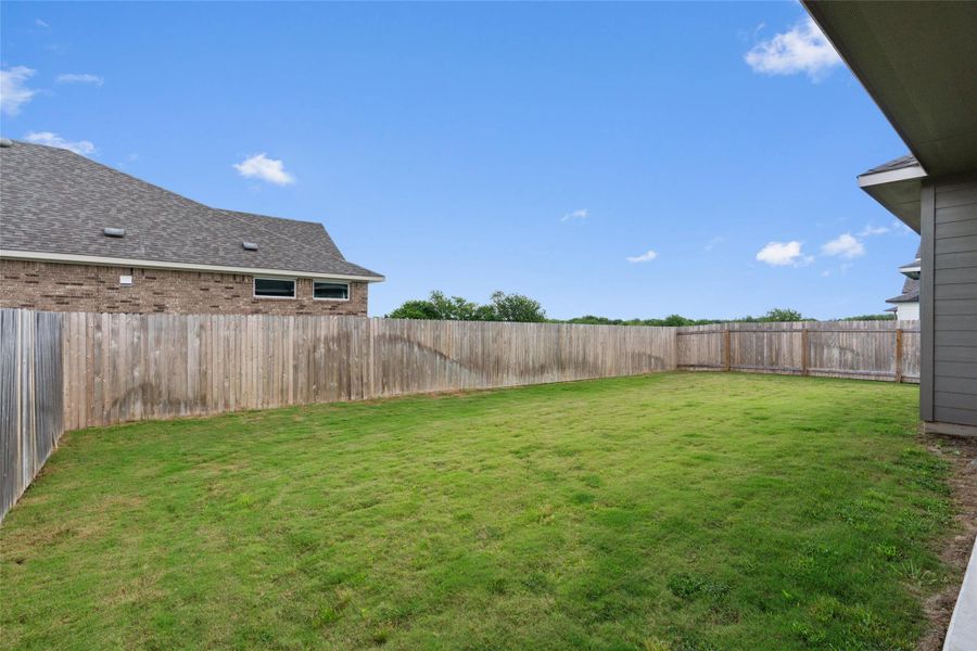 A fully fenced backyard offers a private green space for outdoor activities and enjoyment.