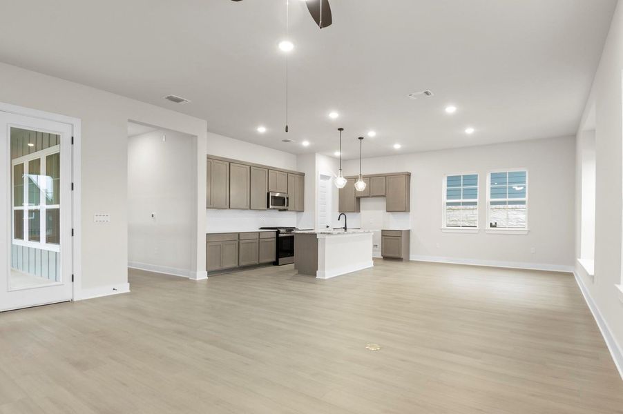 Unfurnished living room with light wood-style flooring, a ceiling fan, and recessed lighting