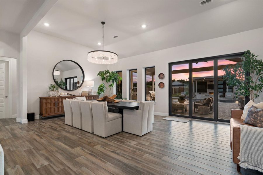 An open dining area with seamless patio access for indoor-outdoor entertaining. An open dining area with seamless patio access for indoor-outdoor entertaining.