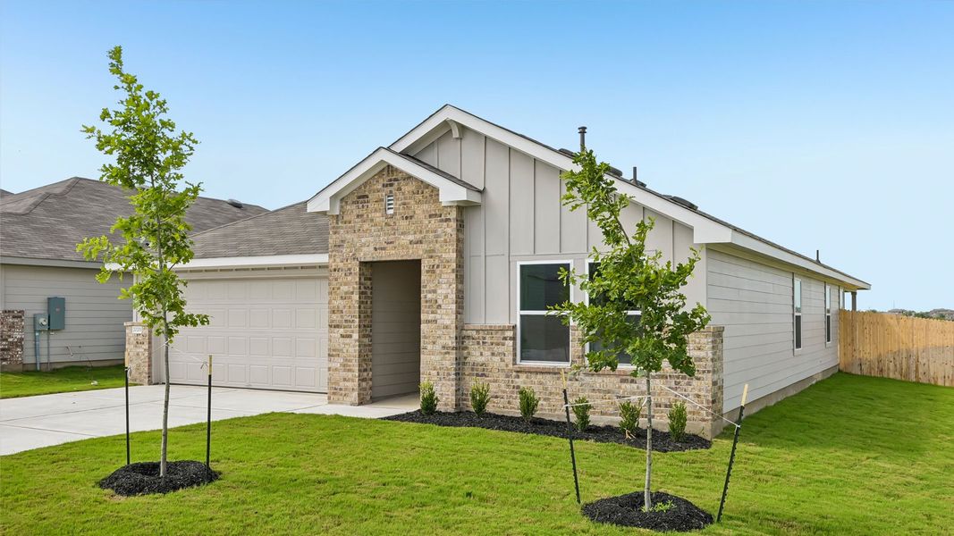 Front exterior of a new home in Carillon, Manor, TX, highlighting curb appeal (Image 18).