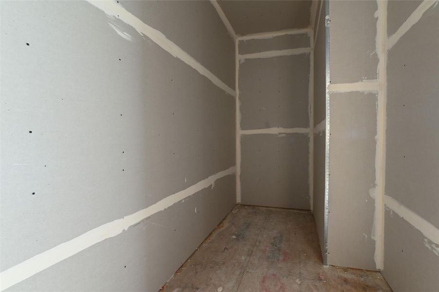 Primary bedroom walk-in closet