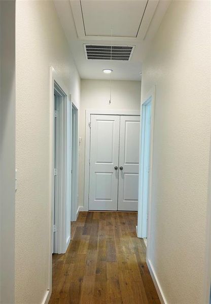 Hallway with dark hardwood / wood-style flooring