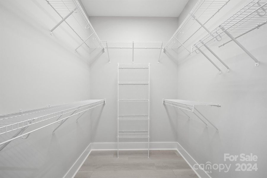 Primary bedroom walk in closet