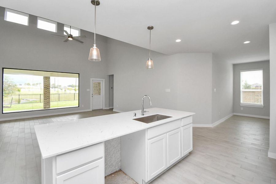 All of this overlooks your expansive family room, creating a perfect space for culinary delights and family gatherings. Sample photo of completed home with similar floor plan. Actual colors and selections may vary. All of this overlooks your expansive family room, creating a perfect space for culinary delights and family gatherings. Sample photo of completed home with similar floor plan. Actual colors and selections may vary.