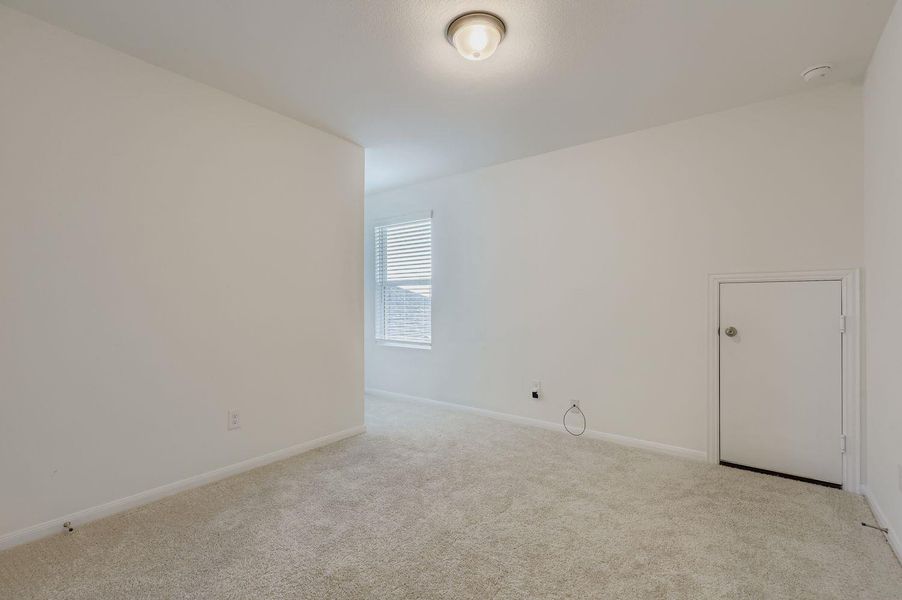 Carpeted spare room with baseboards