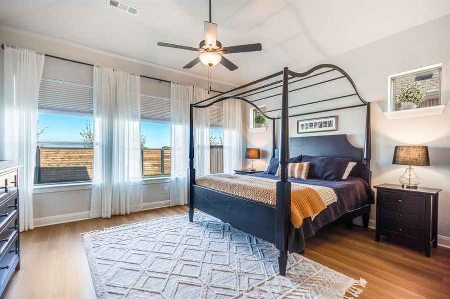 Bedroom with light wood finished floors and a ceiling fan