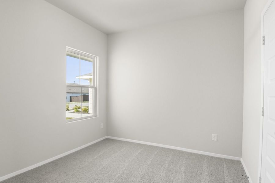 Image of bedroom with light grey carpet and walls with a window Image of bedroom with light grey carpet and walls with a window