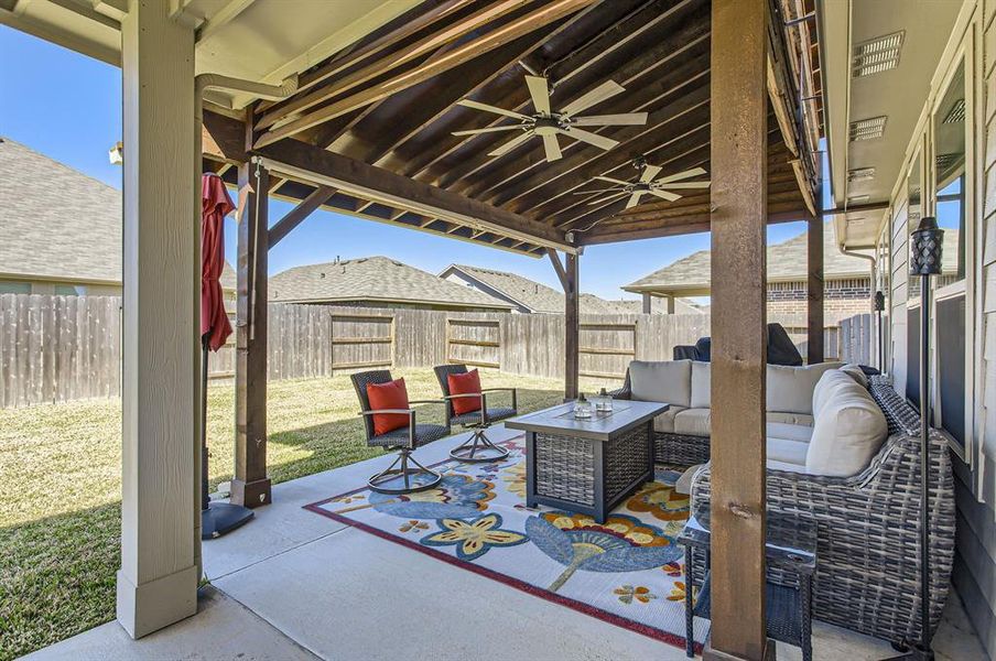 In addition to the covered patio built with the house, the current home owners added this double-sized covered patio with two ceiling fans, making the backyard oasis perfect for a night of entertaining!