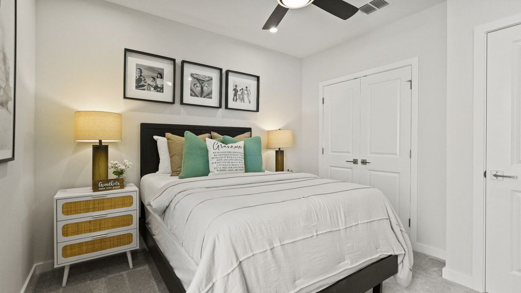Guest bedroom at The Atlantic features sleek finishes, double-door closet, and space-saving layout with modern flair.