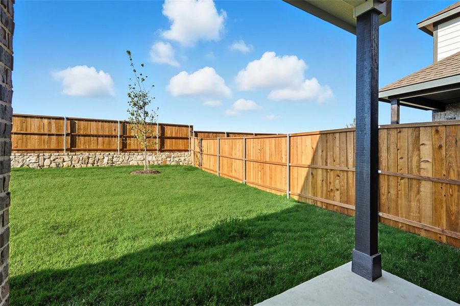 Fenced backyard featuring a patio area Fenced backyard featuring a patio area