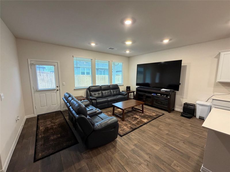 Living room featuring dark wood-style floors and recessed lighting