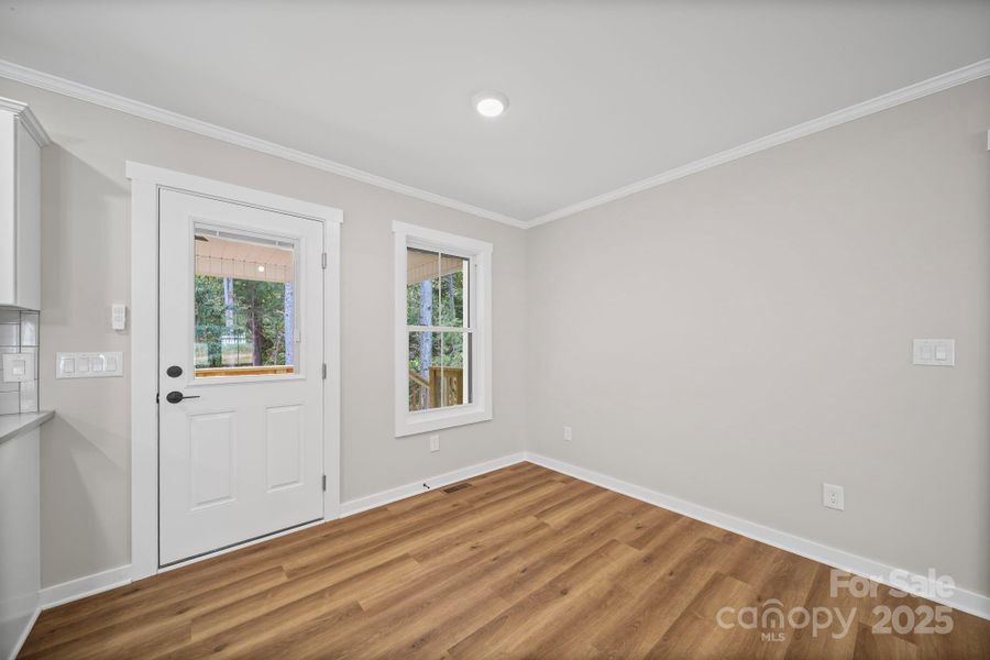 Dining area with exterior door to covered back patio. Dining area with exterior door to covered back patio.