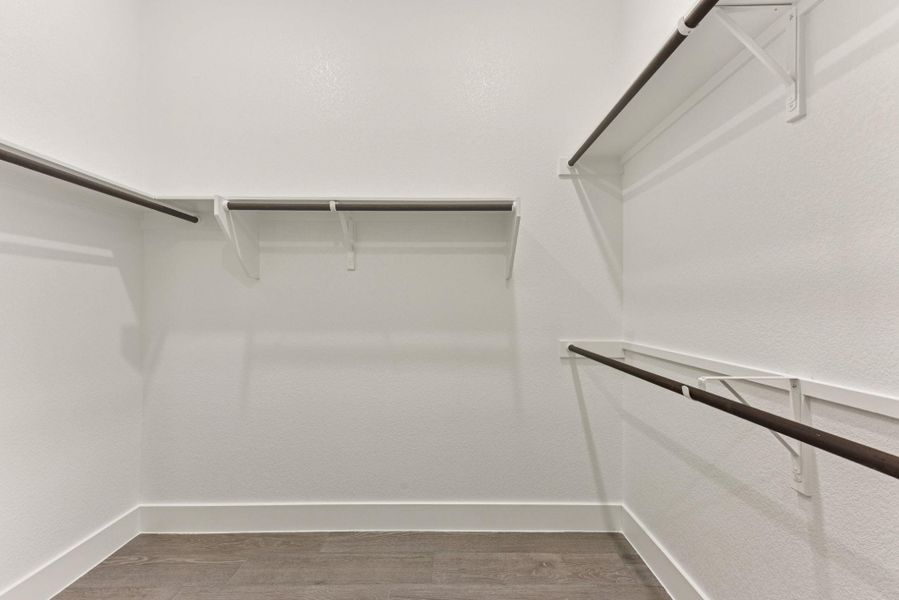 Walk in closet with dark wood-type flooring Walk in closet with dark wood-type flooring