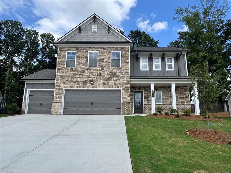 Front exterior of a new home in Rosewood Lake Preserve, Hoschton, GA, highlighting curb appeal (Image 23).