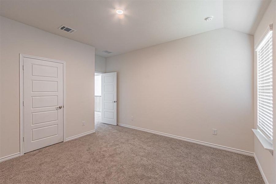 Unfurnished bedroom with light carpet