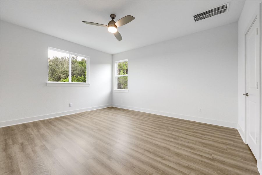 Large primary bedroom with great lighting.