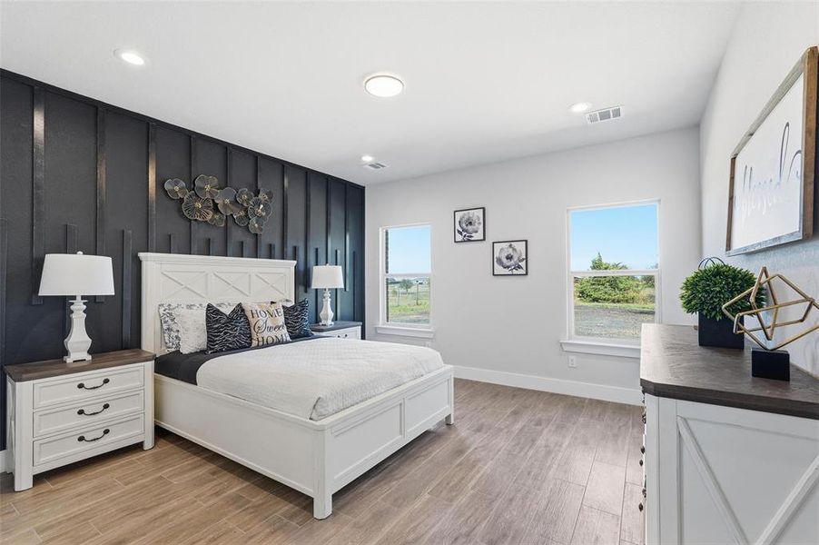 Bedroom with light wood-style flooring and recessed lighting