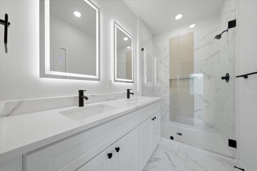 Primary bathroom features double sinks.