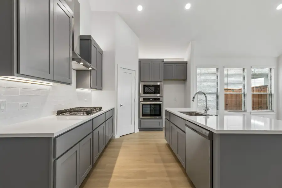 Kitchen in the Claret home plan by Trophy Signature Homes – REPRESENTATIVE PHOTO