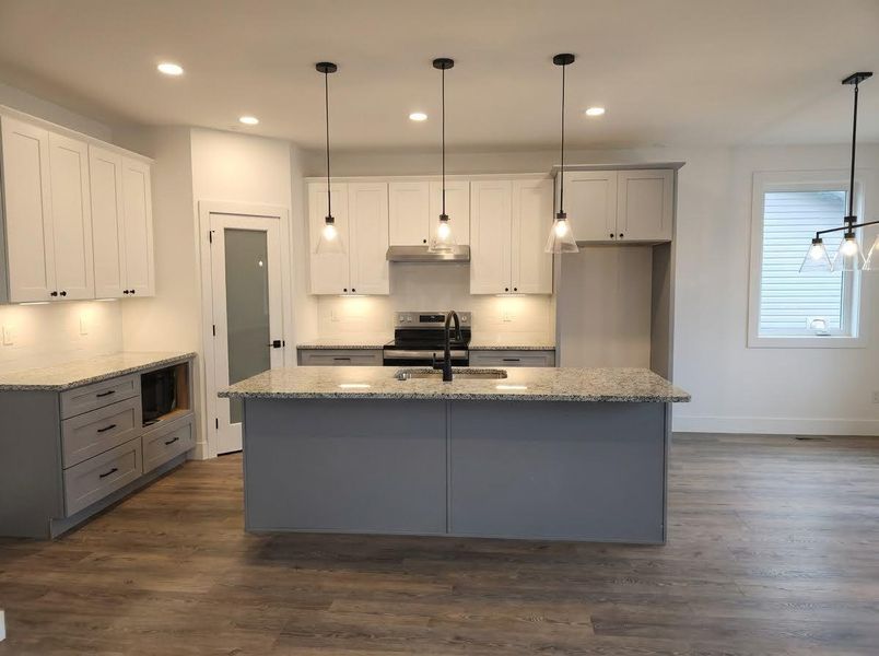 Kitchen featuring gray cabinetry, light stone countertops, dark wood-style flooring, and recessed lighting