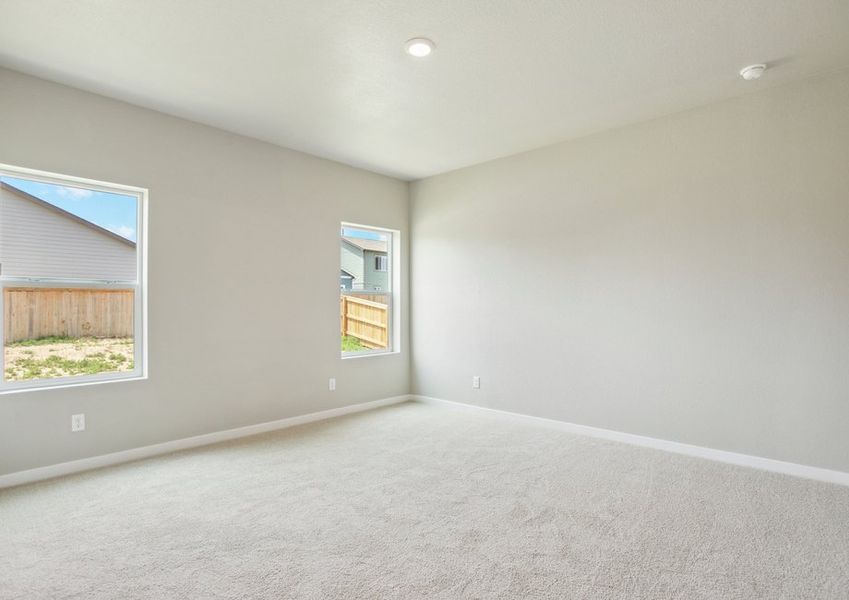 The master bedroom has carpet and large windows.