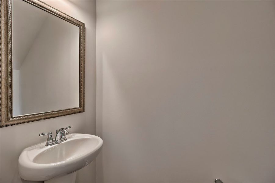 This bathroom features a sleek wall-mounted sink w