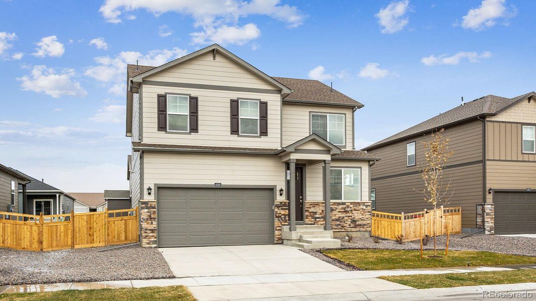 Front exterior of a new home in Silver Peaks, Lochbuie, CO, highlighting curb appeal (Image 20).