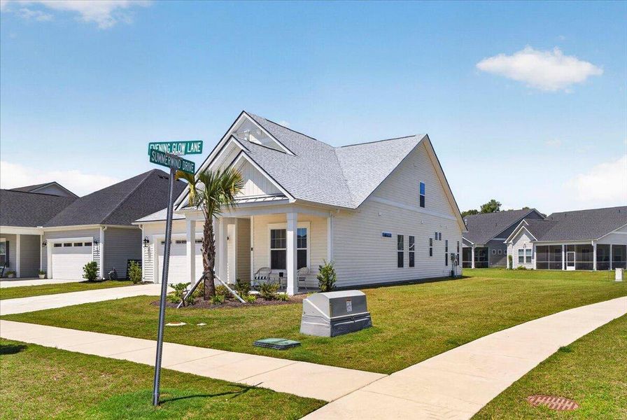 Front exterior of a new home in Summerwind Crossing at Lakes of Cane Bay, Summerville, SC, highlighting curb appeal (Image 24).