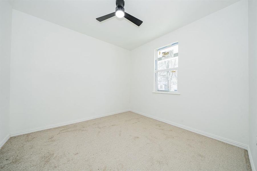 2nd bedroom with carpet floors and ceiling fan