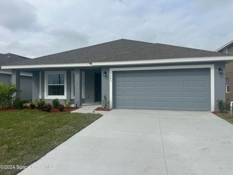 Front exterior of a new home in St. John Preserve, Palm Bay, FL, highlighting curb appeal (Image 1). Front exterior of a new home in St. John Preserve, Palm Bay, FL, highlighting curb appeal (Image 1).