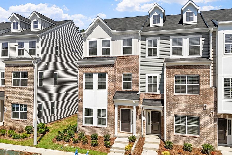 Front exterior of a new home in Renaissance at White Oak, Garner, NC, highlighting curb appeal (Image 18). Front exterior of a new home in Renaissance at White Oak, Garner, NC, highlighting curb appeal (Image 18).