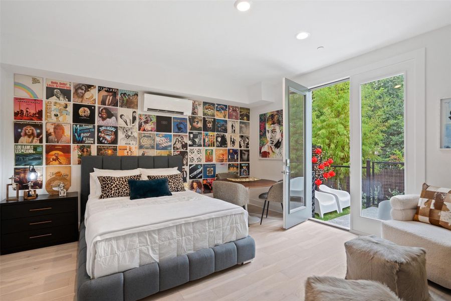 Bedroom featuring wood finished floors, access to exterior, a wall mounted AC, and recessed lighting