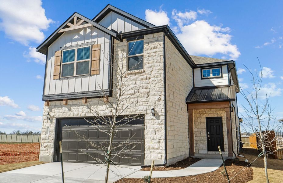 Front exterior of a new home in Santa Rita Ranch, Liberty Hill, TX, highlighting curb appeal (Image 21).
