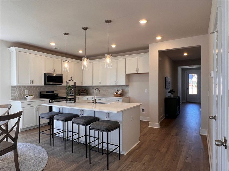 This modern kitchen features a spacious island, st This modern kitchen features a spacious island, st