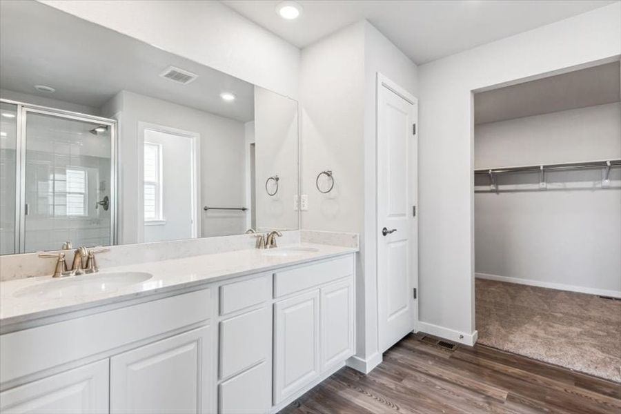 A bathroom with white cabinets.