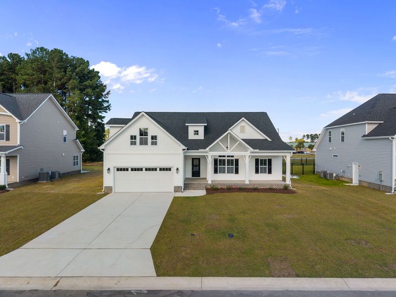 Front exterior of a new home in The Preserve at Langston, Winterville, NC, highlighting curb appeal (Image 26).