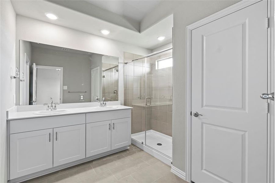 Full bath with double vanity, a stall shower, recessed lighting, and tile patterned floors Full bath with double vanity, a stall shower, recessed lighting, and tile patterned floors