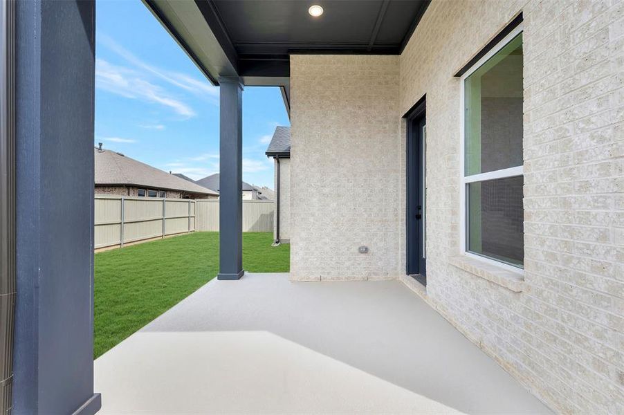 Fenced backyard with a patio area