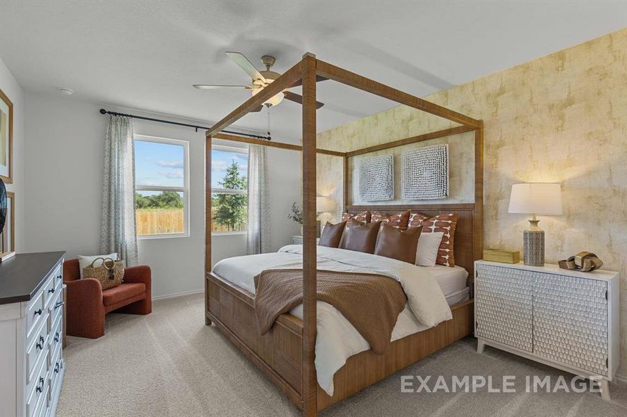 Carpeted bedroom featuring ceiling fan