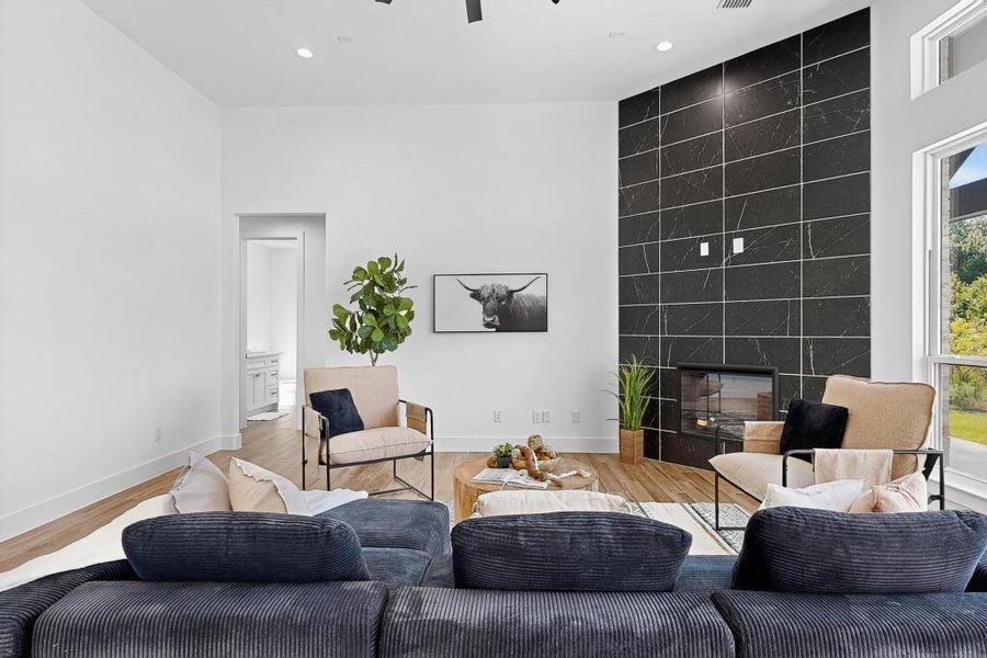Living area with wood finished floors, a fireplace, recessed lighting, and a ceiling fan