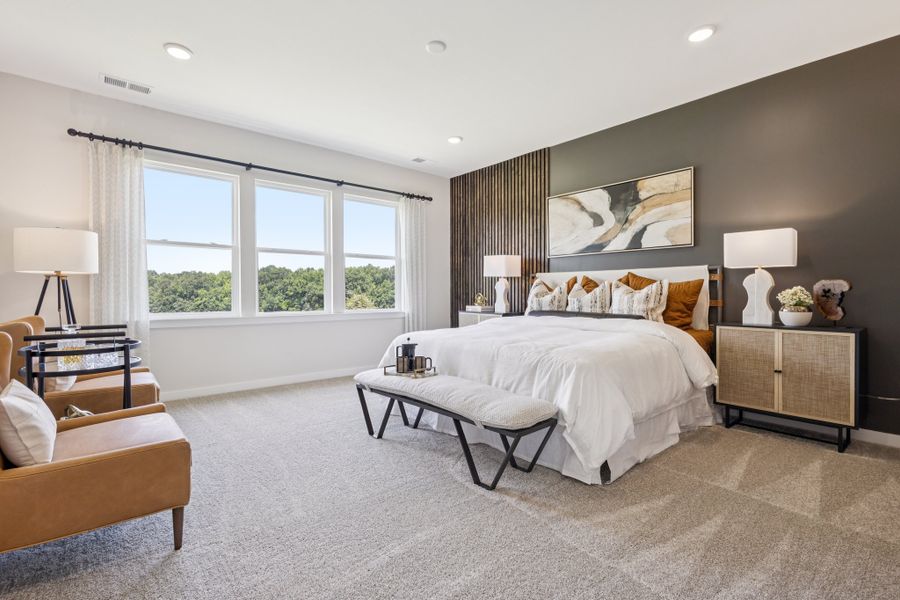 A bedroom with a bed and a table. A bedroom with a bed and a table.