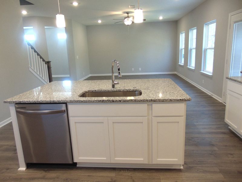 The kitchen where you can cook all your specialty dishes with love. This kitchen has under cabinet lights, included steel appliances, as well as a modern and large island and sink.