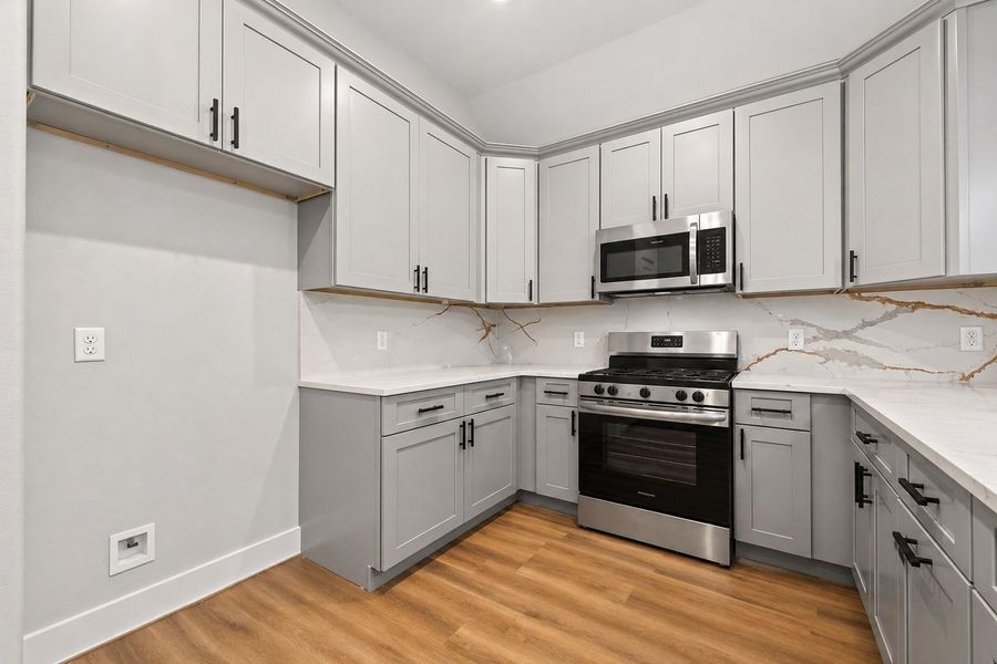 Thoughtfully designed kitchen featuring a large island, ample cabinetry, and an open flow to the main living areas.