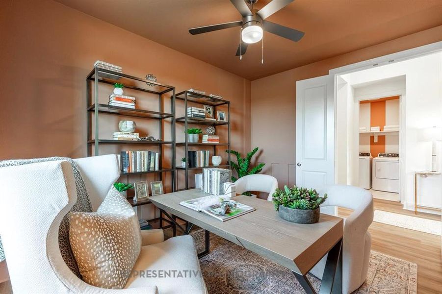 Home office featuring wood finished floors, washer and clothes dryer, and a ceiling fan