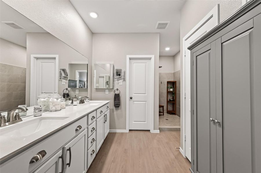 Primary bath with dual vanities, ample storage, and generous counter space. Primary bath with dual vanities, ample storage, and generous counter space.