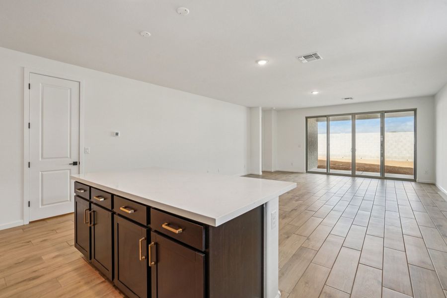 Kitchen and great room. Finishes may vary by community.