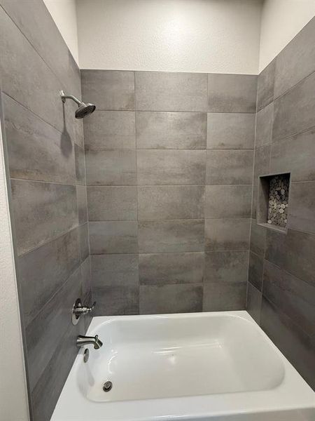 Bathroom featuring washtub / shower combination