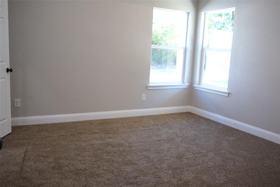 Empty room featuring carpet and baseboards Empty room featuring carpet and baseboards