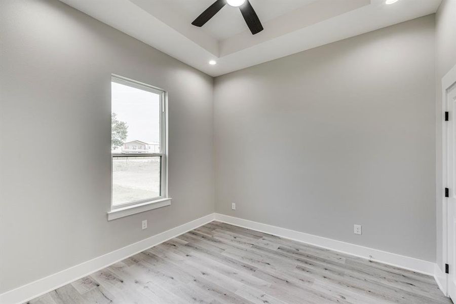 Empty room featuring light hardwood / wood-style floors and ceiling fan