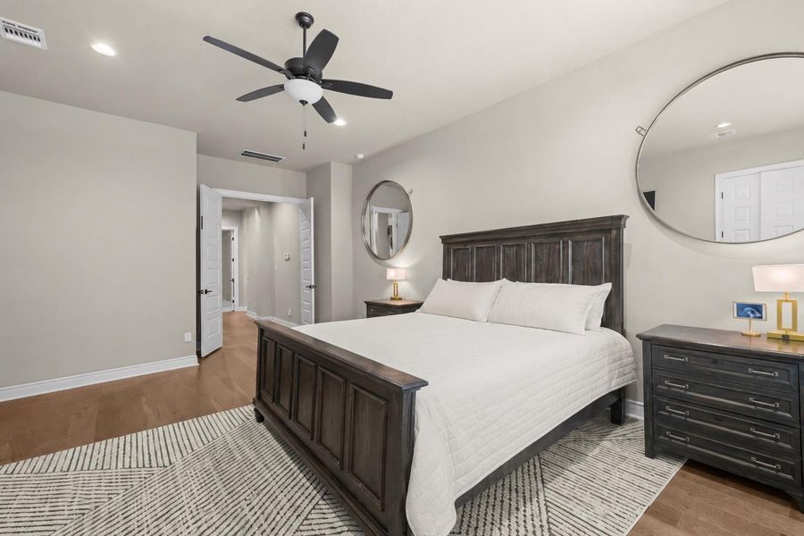 Well-lit sleeping quarters with a ceiling fan, durable flooring, and convenient entry to adjoining spaces. Well-lit sleeping quarters with a ceiling fan, durable flooring, and convenient entry to adjoining spaces.